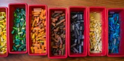 several containers full of colored chalk