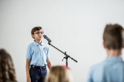 boy talking into a microphone