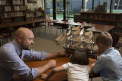 Adult and children looking at a ship